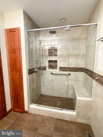 a bathroom with a glass shower door