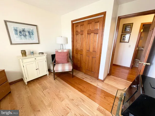 a living room with furniture and a baby crib