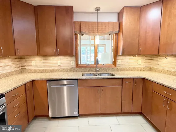 a kitchen with stainless steel appliances granite countertop a sink and cabinets