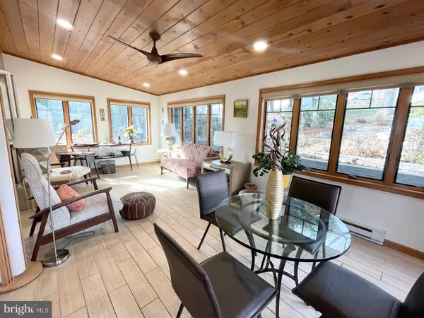 a living room with furniture and a floor to ceiling window