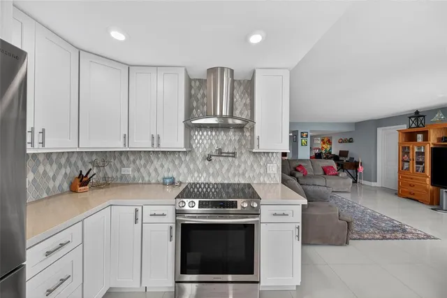 a kitchen with a table chairs refrigerator and cabinets