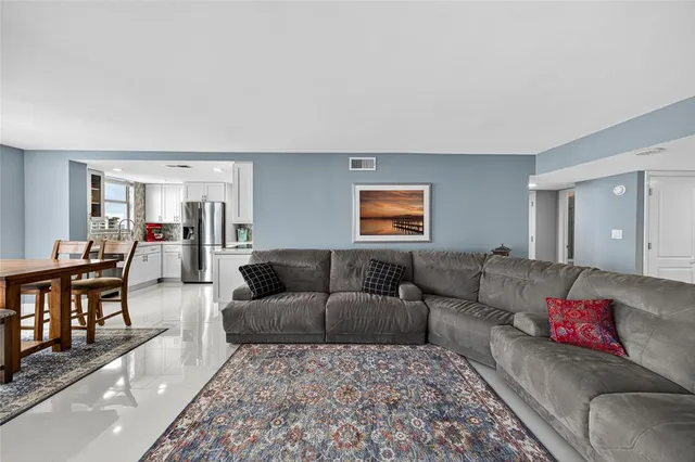 a bedroom with a bed couch and a flat screen tv