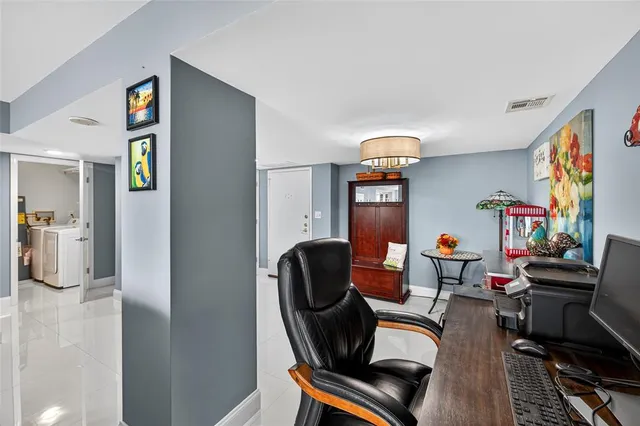 a living room with furniture and large windows