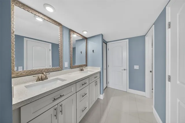 a kitchen with granite countertop a sink stove and cabinets