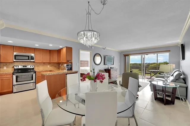 a view of a dining room with furniture and chandelier