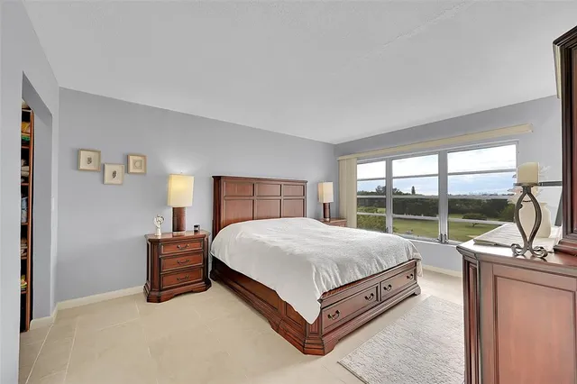 a bedroom with a large bed and a dresser