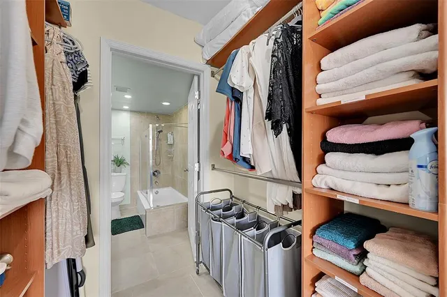 a bedroom with a bed and large window