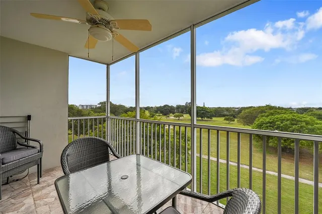 a living room with stainless steel appliances kitchen island granite countertop furniture wooden floor and a view of living room