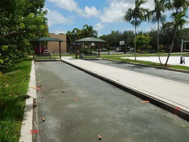 a view of a cafe with a table and chairs under an umbrella