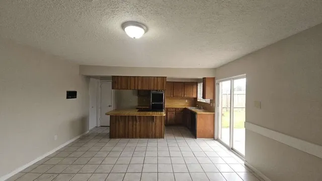 a kitchen with kitchen island a sink a counter top space and appliances