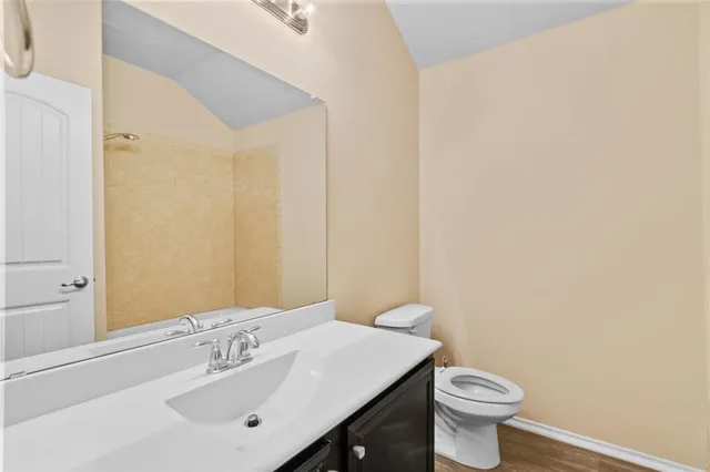 a bathroom with a sink a toilet and mirror