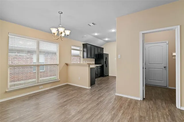a view of a kitchen with wooden floor and a kitchen