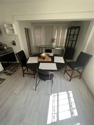 a workspace with wooden floor and furniture