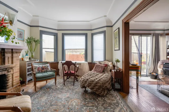 a living room with furniture and a floor to ceiling window