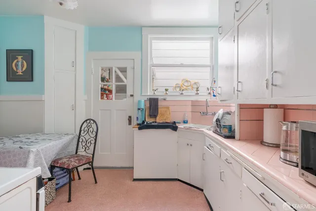 a kitchen with a sink cabinets and window