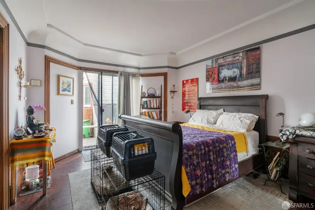 a bedroom with a bed couch and a large window