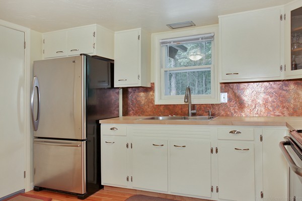 561 Leadmine Road Sturbridge, MA 01566 - Photo 4 of 21 a kitchen with refrigerator a sink and cabinets