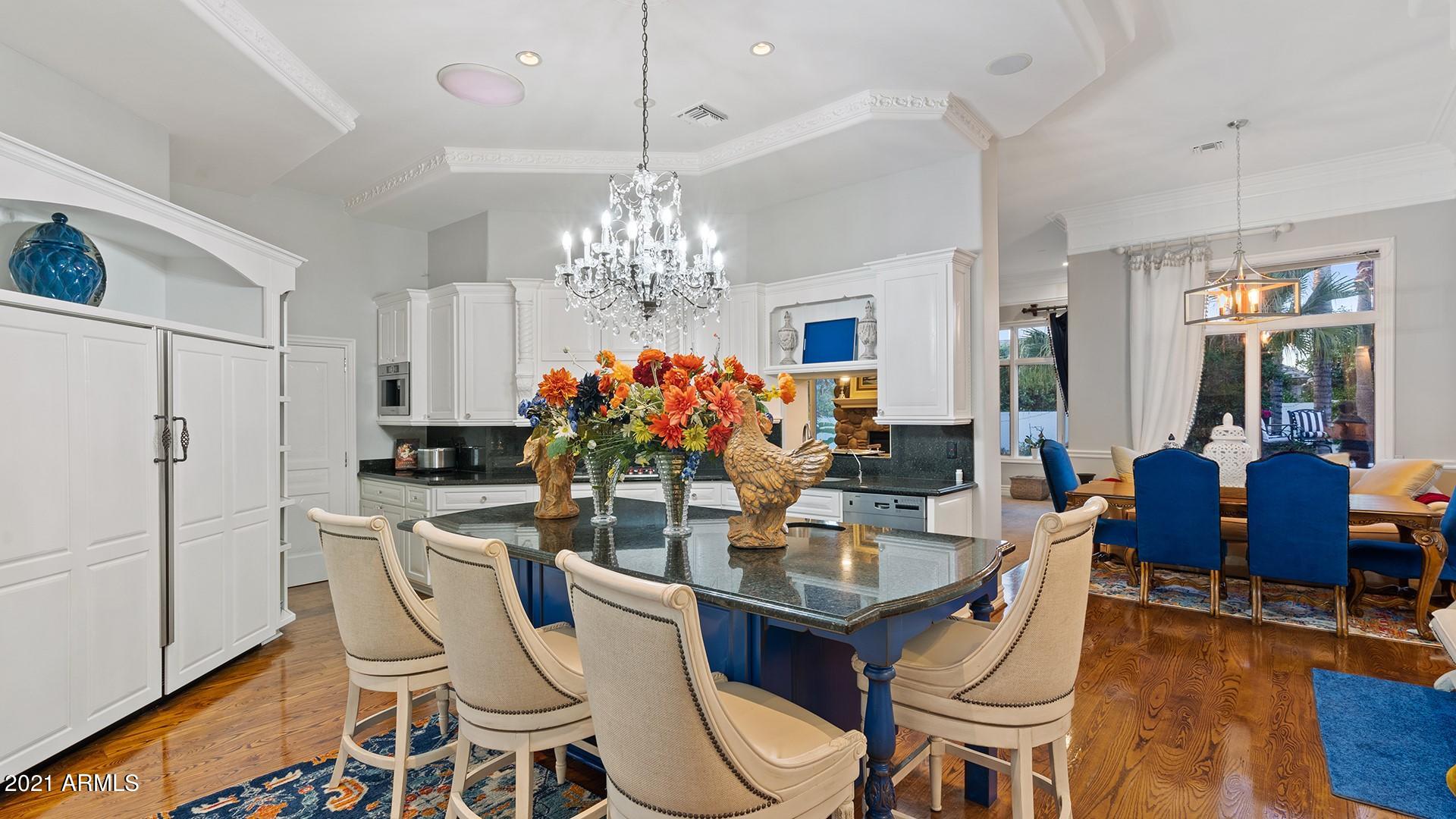 4040 East McLellan Road, Unit 8 Mesa, AZ 85205 - Photo 23 of 105 a view of a dining room with furniture a chandelier and wooden floor