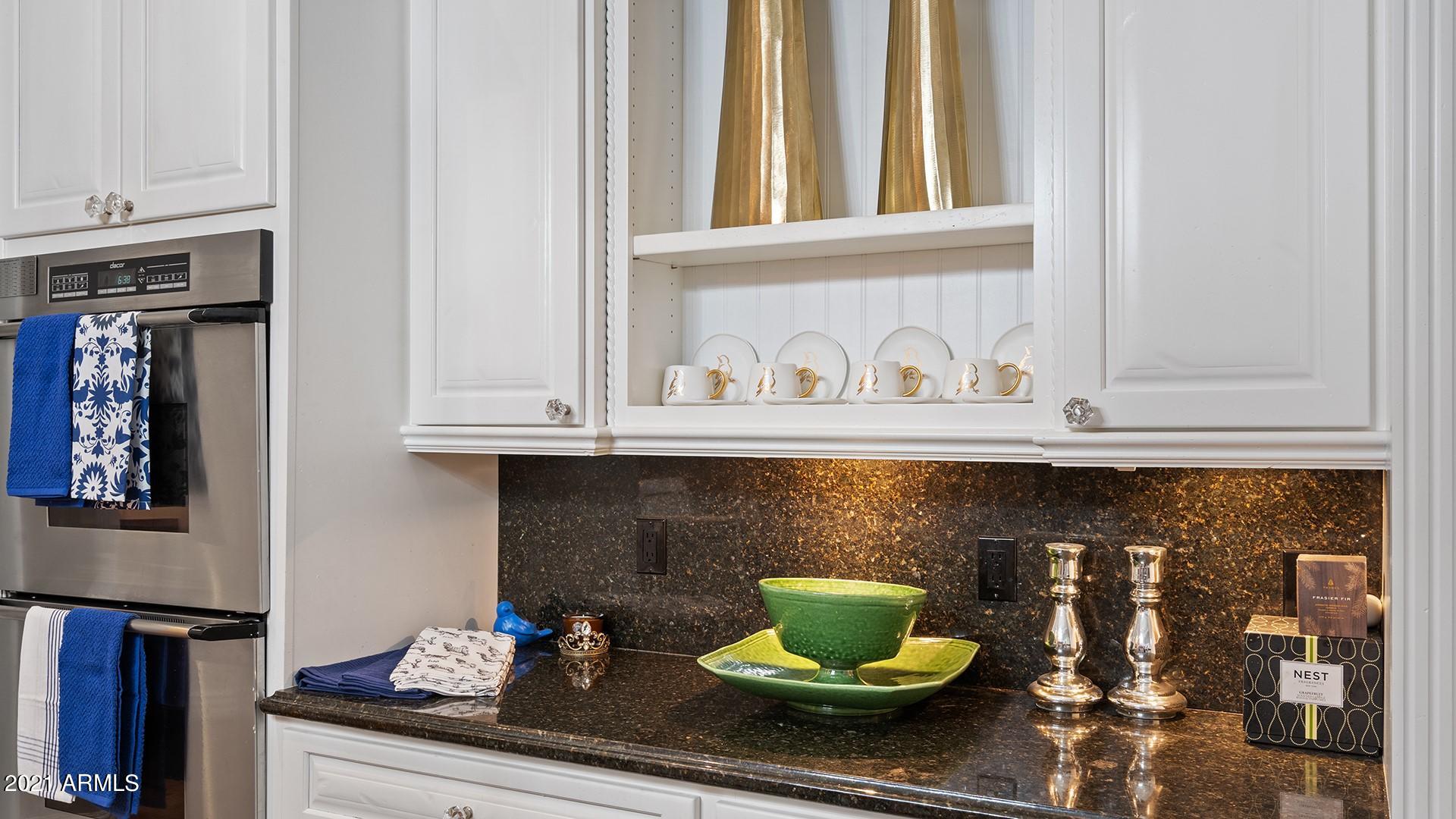 4040 East McLellan Road, Unit 8 Mesa, AZ 85205 - Photo 27 of 105 a kitchen with a stove and a potted plant