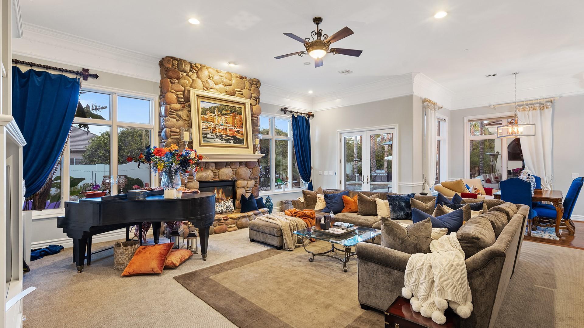 4040 East McLellan Road, Unit 8 Mesa, AZ 85205 - Photo 32 of 105 a living room filled with furniture and a chandelier