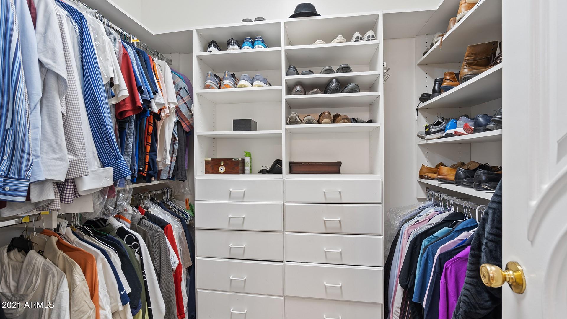 4040 East McLellan Road, Unit 8 Mesa, AZ 85205 - Photo 48 of 105 a view of walk in closet with clothes and shoes