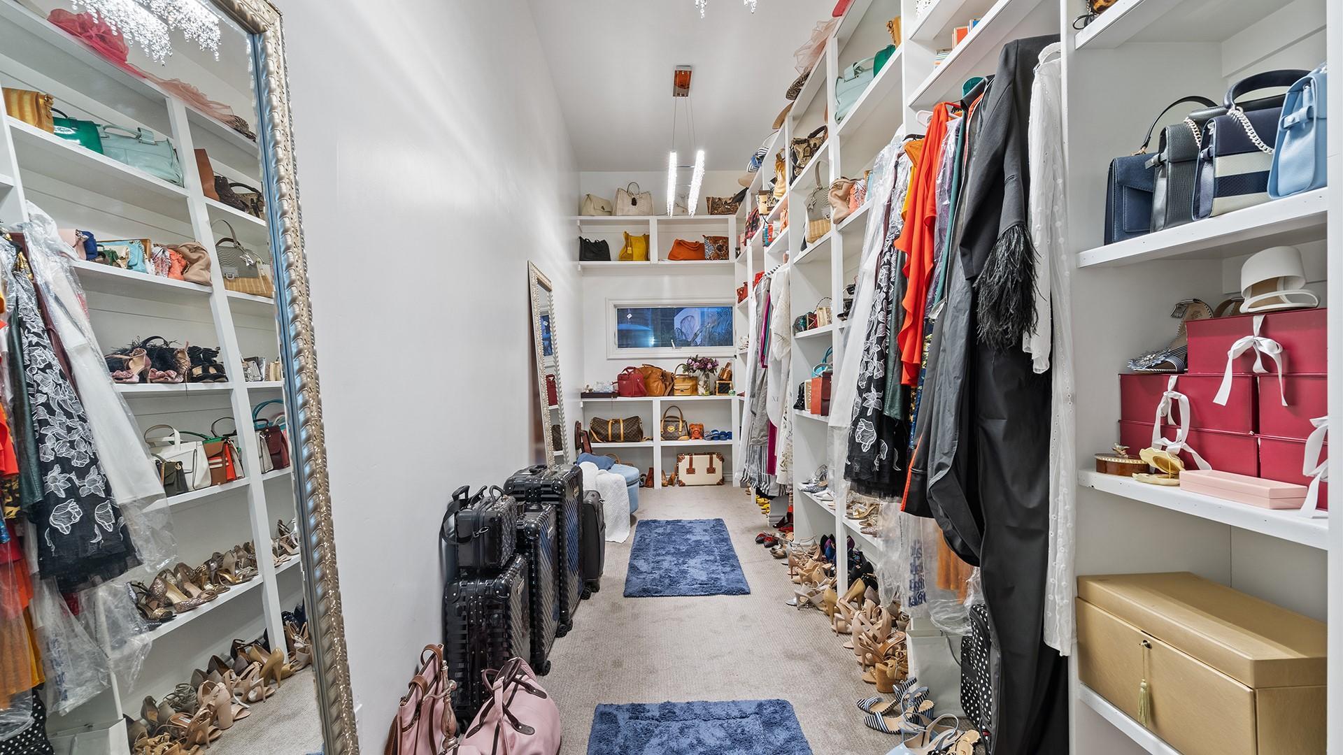 4040 East McLellan Road, Unit 8 Mesa, AZ 85205 - Photo 49 of 105 a view of walk in closet with clothes and shoes