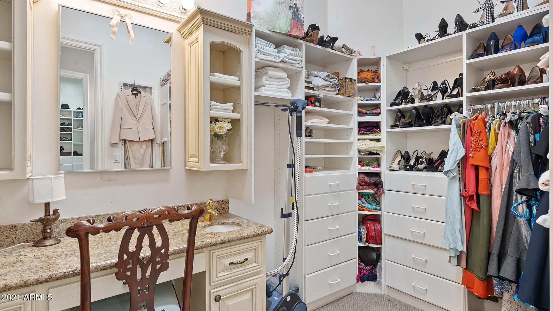 4040 East McLellan Road, Unit 8 Mesa, AZ 85205 - Photo 50 of 105 a view of walk in closet with clothes and shoes
