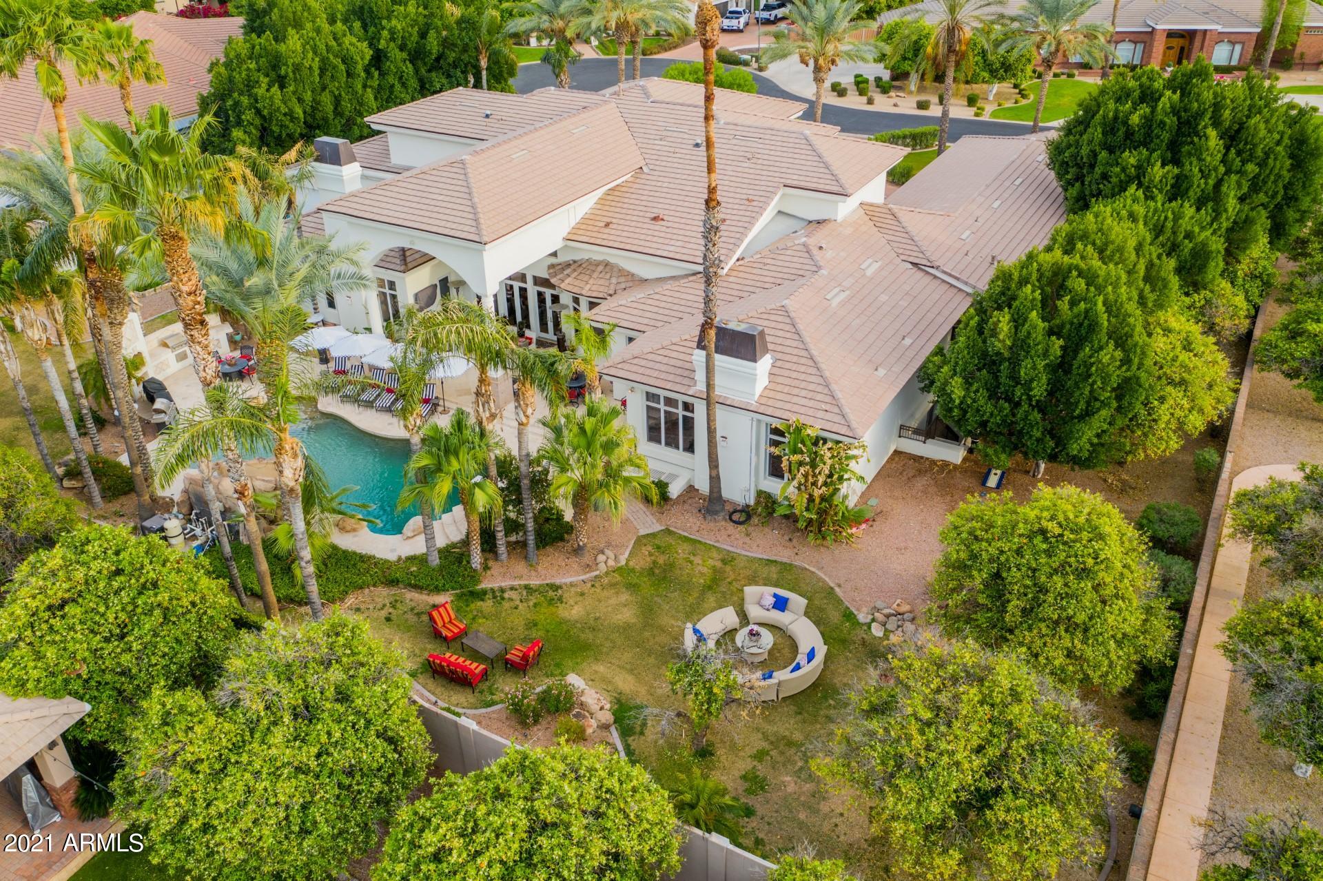 4040 East McLellan Road, Unit 8 Mesa, AZ 85205 - Photo 67 of 105 an aerial view of a house with a garden and lake view