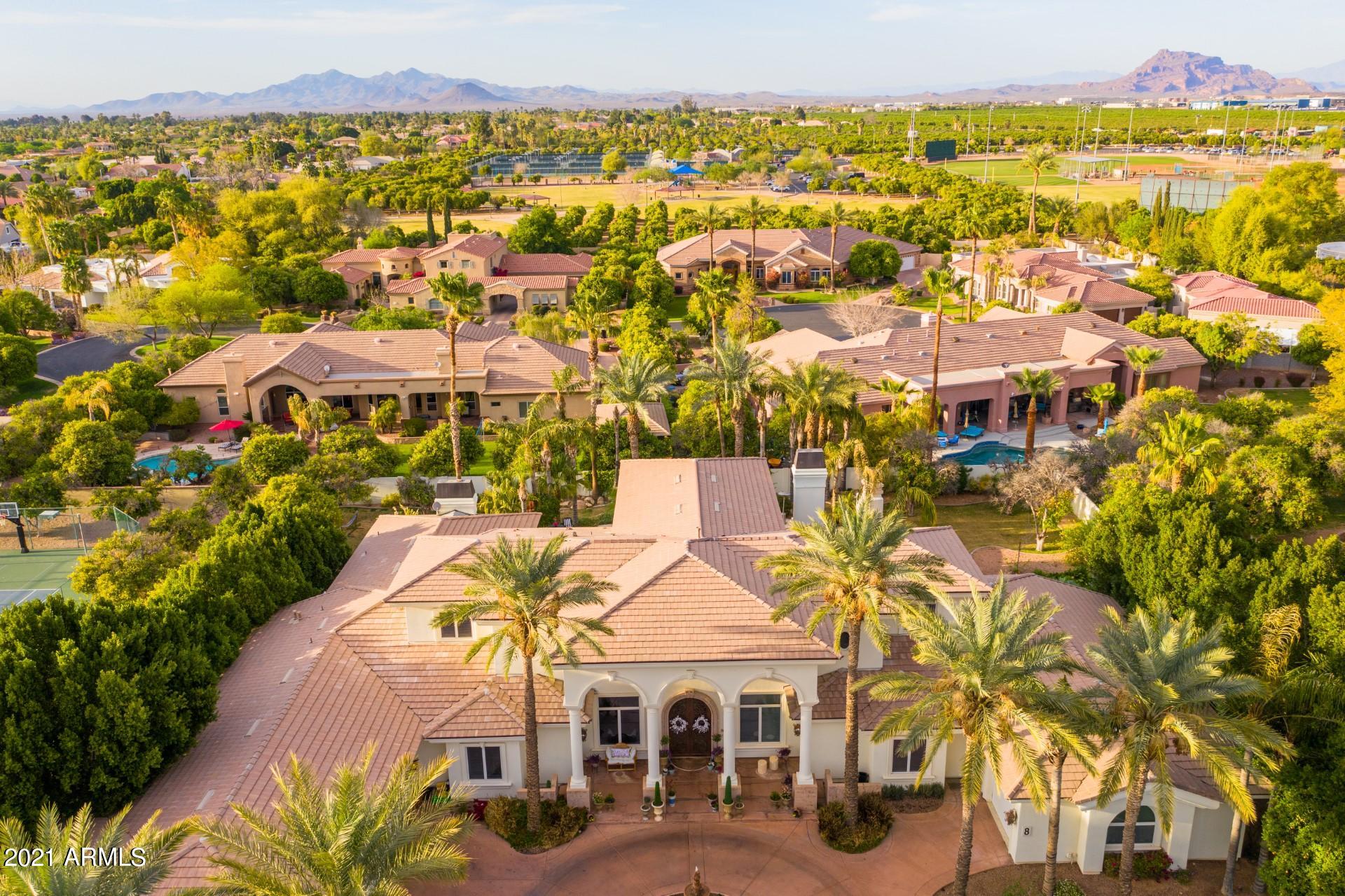4040 East McLellan Road, Unit 8 Mesa, AZ 85205 - Photo 71 of 105 an aerial view of residential houses with outdoor space and swimming pool