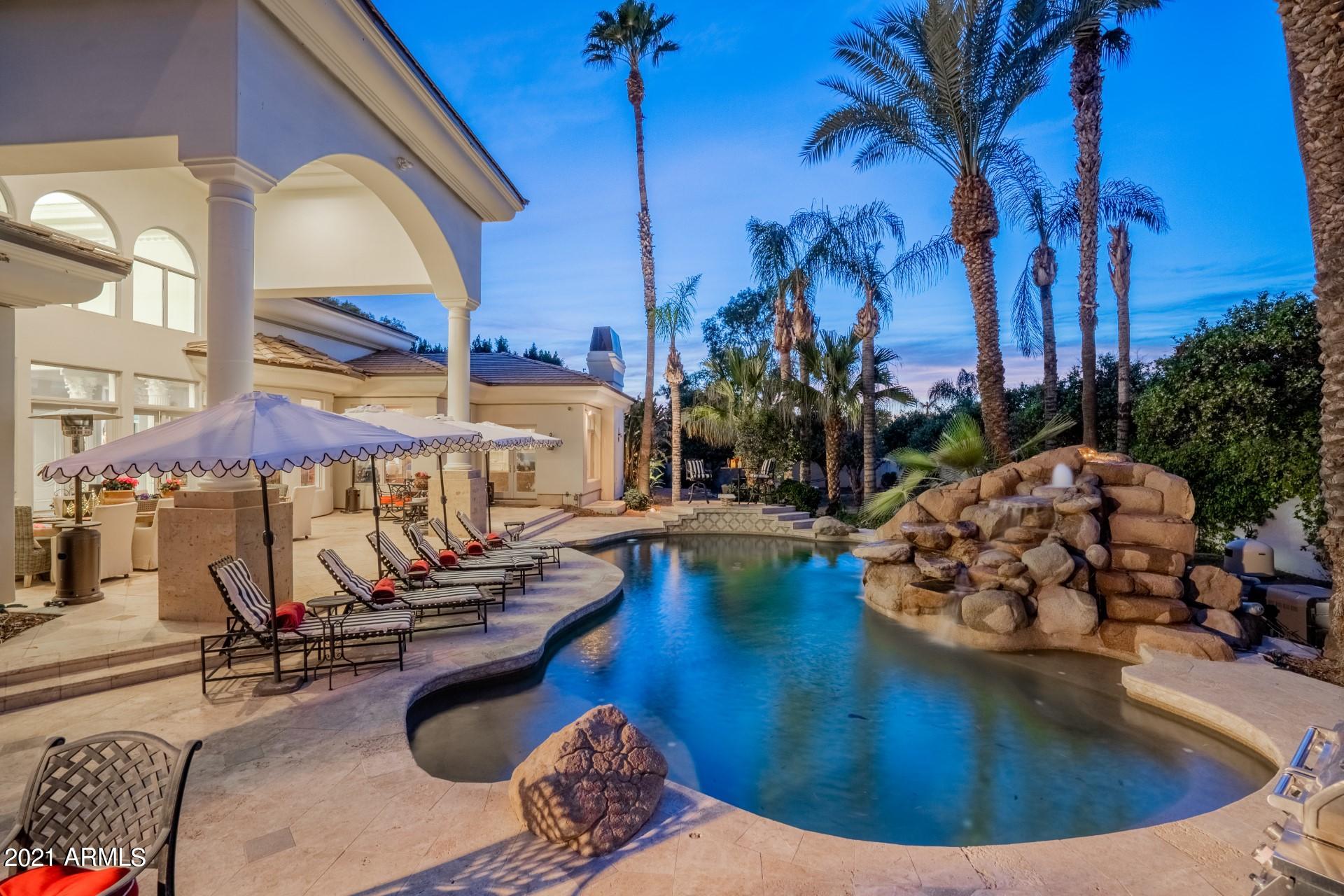 4040 East McLellan Road, Unit 8 Mesa, AZ 85205 - Photo 81 of 105 a view of a swimming pool with outdoor seating and plants
