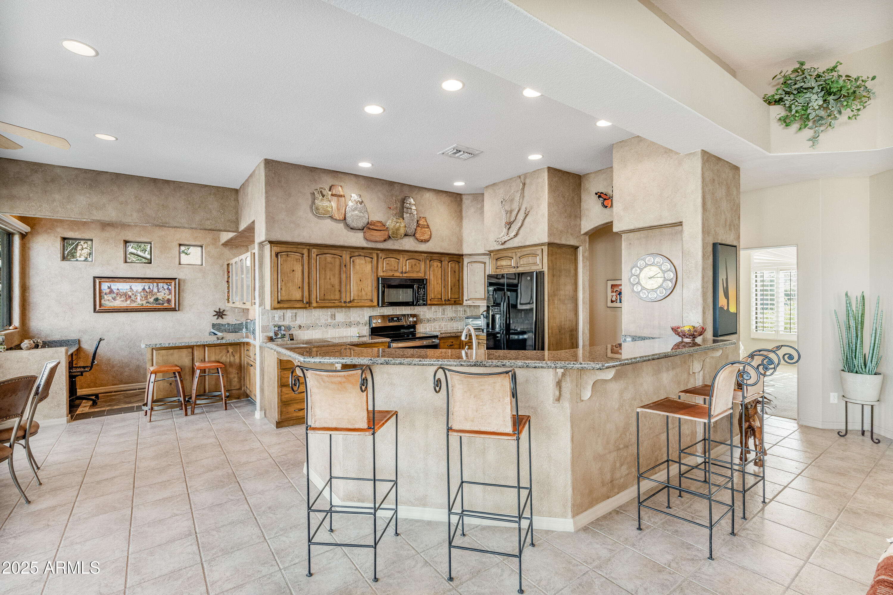18300 North Tonto Verde Drive Rio Verde, AZ 85263 - Photo 11 of 35 a kitchen with stainless steel appliances lots of white furniture a refrigerator a stove a sink a dining table and chairs