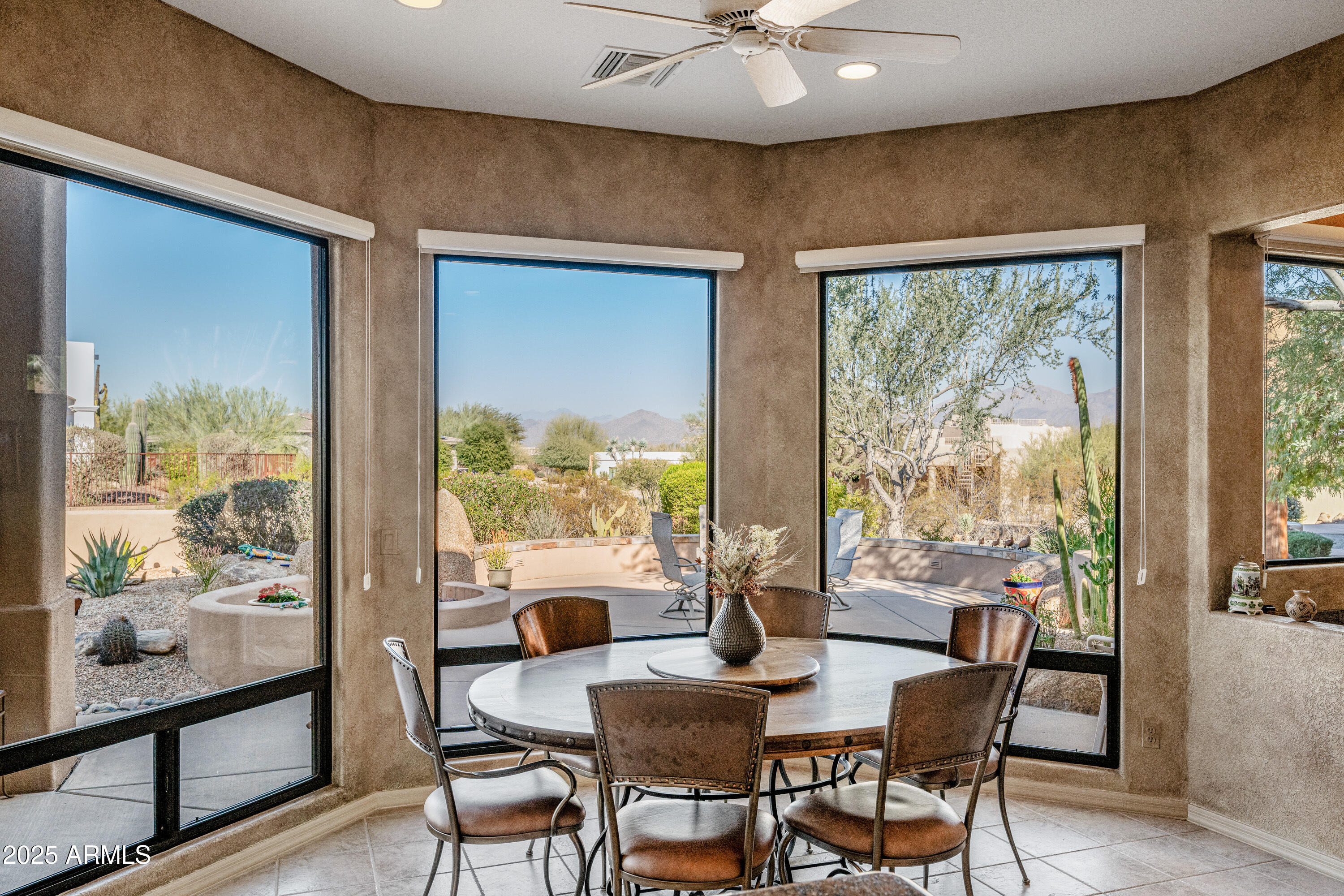 18300 North Tonto Verde Drive Rio Verde, AZ 85263 - Photo 12 of 35 a view of a dining room with furniture large windows and wooden floor