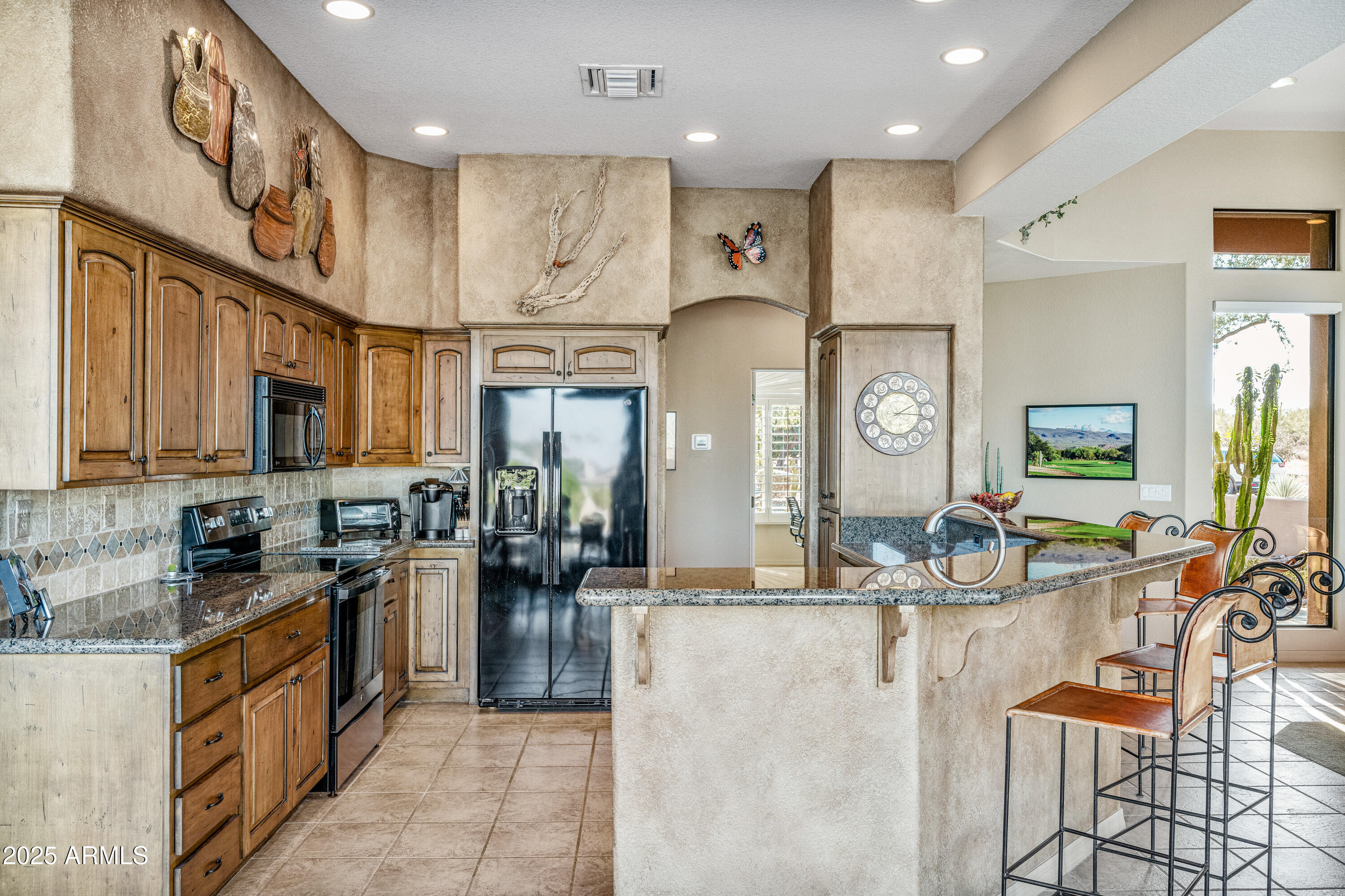 18300 North Tonto Verde Drive Rio Verde, AZ 85263 - Photo 9 of 35 a kitchen with stainless steel appliances kitchen island granite countertop a stove and cabinets