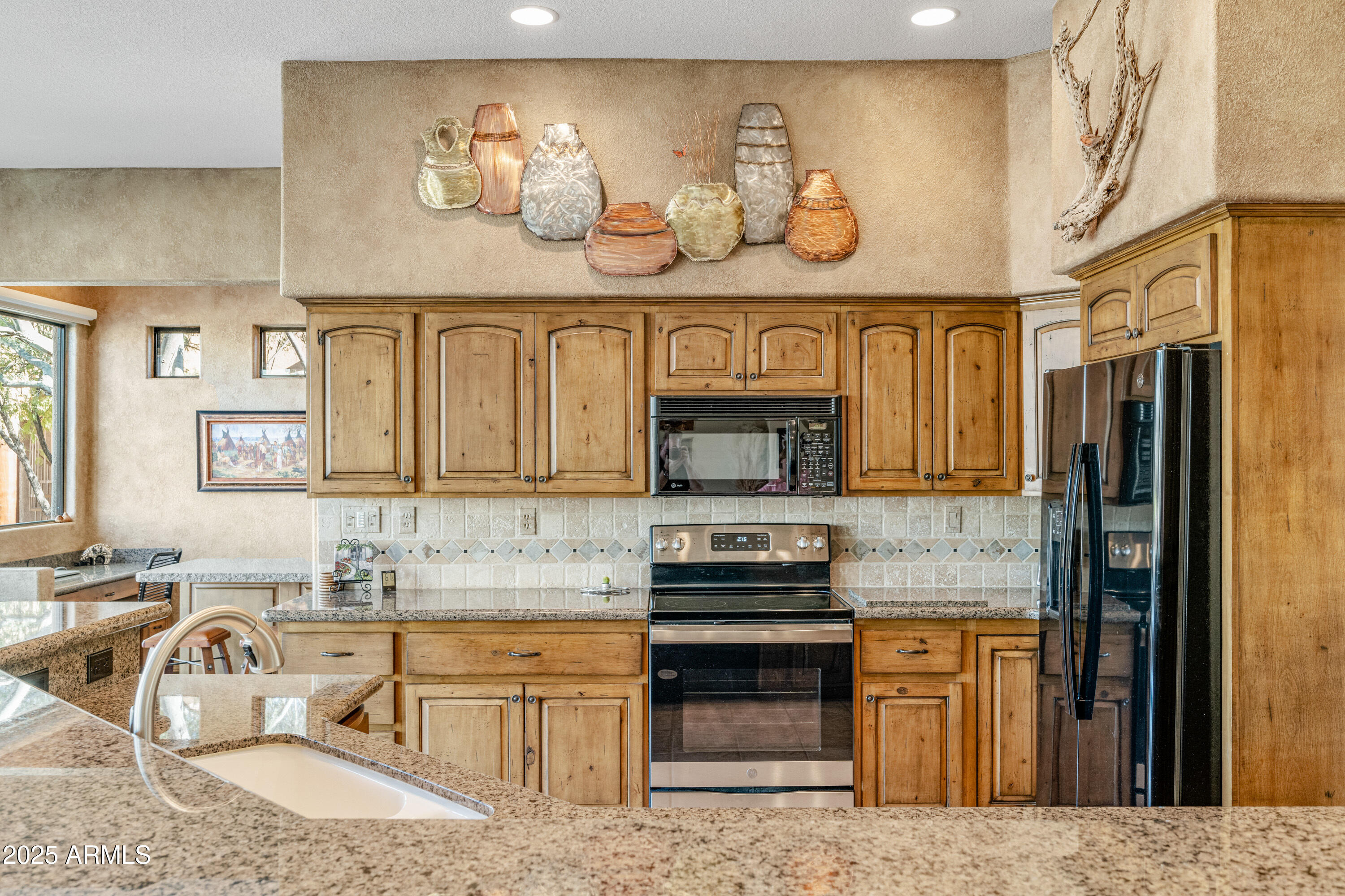 18300 North Tonto Verde Drive Rio Verde, AZ 85263 - Photo 10 of 35 a kitchen with stainless steel appliances granite countertop a sink and cabinets