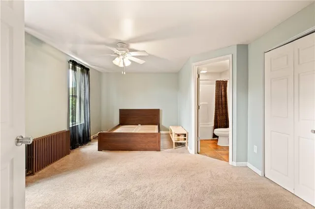 a bedroom with a bed and window