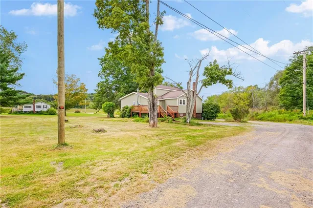 a view of a house with pool and ocean view