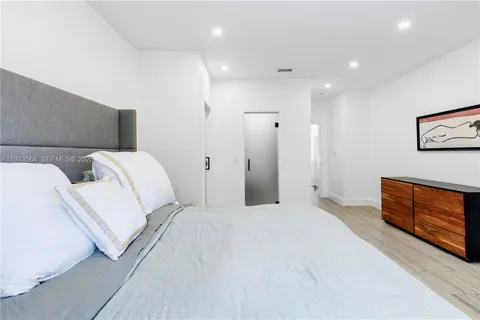 a bedroom with a bed and a couch