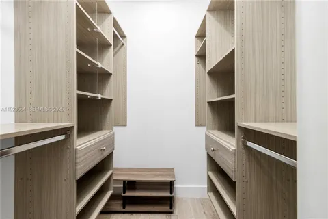 a view of an empty room and kitchen