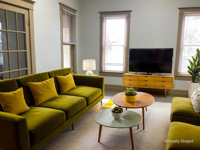 a living room with furniture and a flat screen tv
