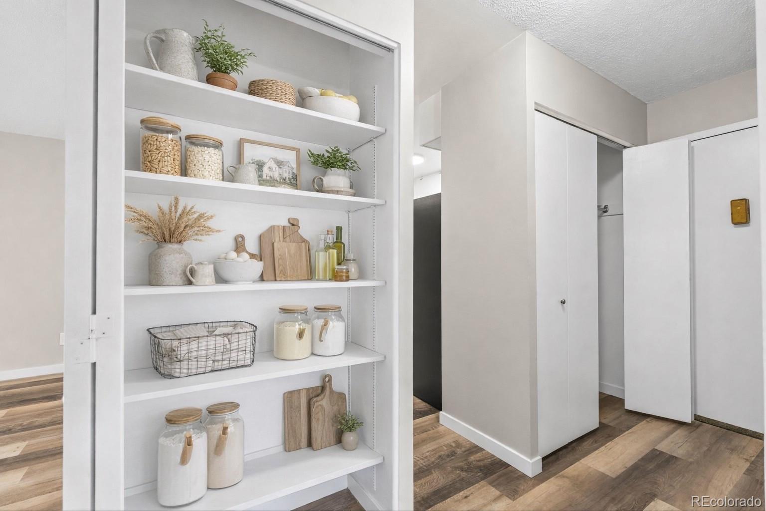 9335 Center Avenue, Unit 1B Denver, CO 80247 - Photo 4 of 15 a view of kitchen cabinets with wooden floor