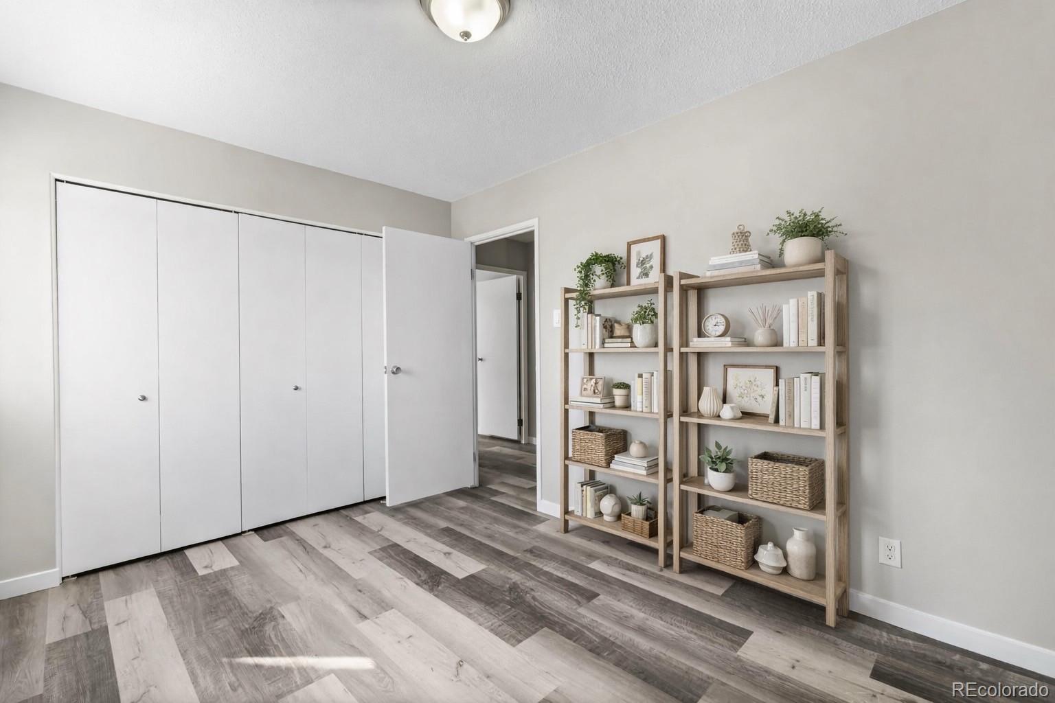 9335 Center Avenue, Unit 1B Denver, CO 80247 - Photo 10 of 15 a view of a livingroom with shelves