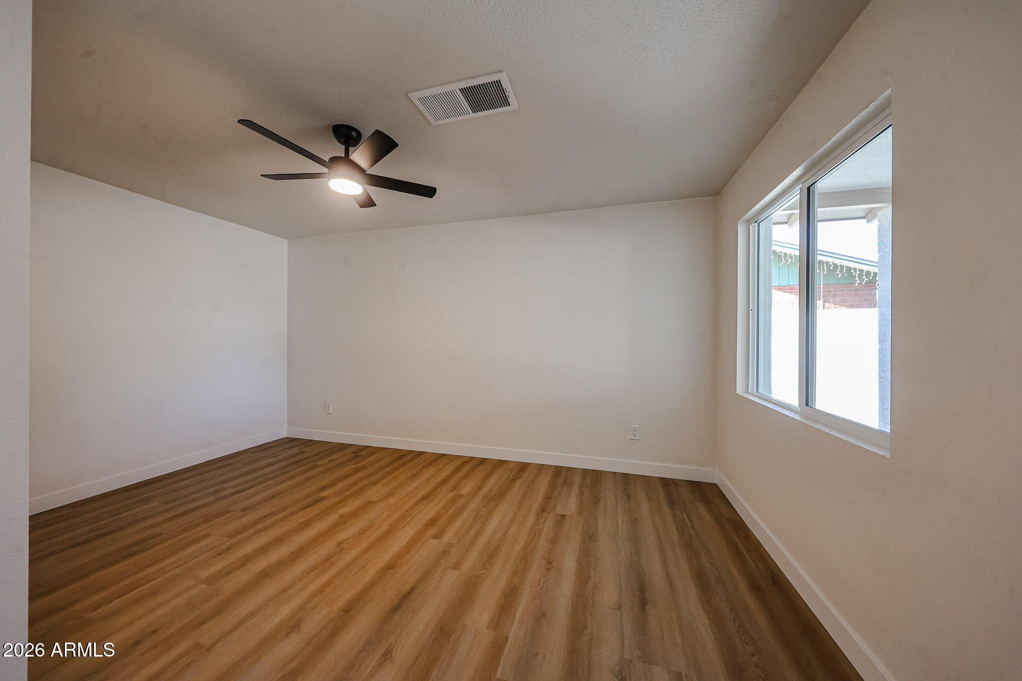 3337 West Ocotillo Road Phoenix, AZ 85017 - Photo 10 of 30 wooden floor in an empty room with a window
