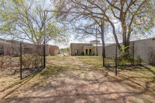 a view of a house with a yard covered with snow