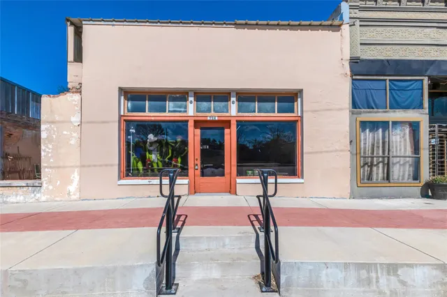 a front view of a building with glass windows and door