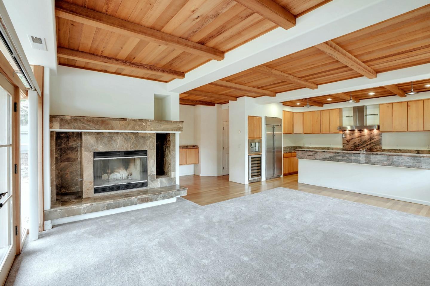 Se Corner Se Corner Carmel, CA 93923 - Photo 17 of 35 a view of an empty room with a fireplace and a ceiling fan
