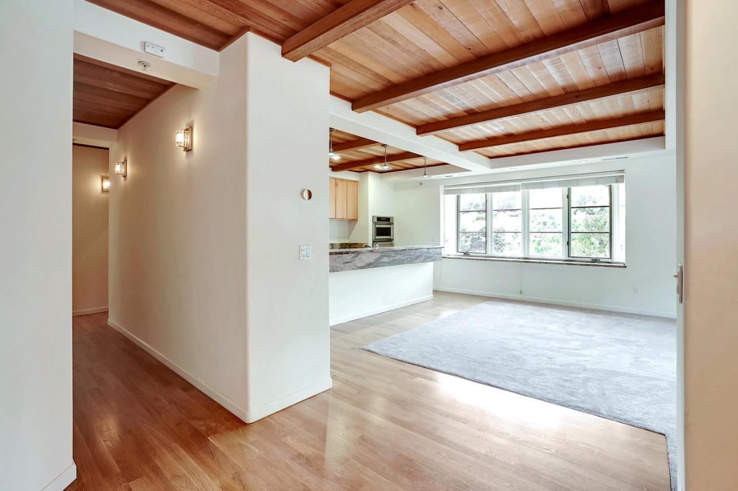Se Corner Se Corner Carmel, CA 93923 - Photo 23 of 35 a view of a hallway with wooden floor and a kitchen