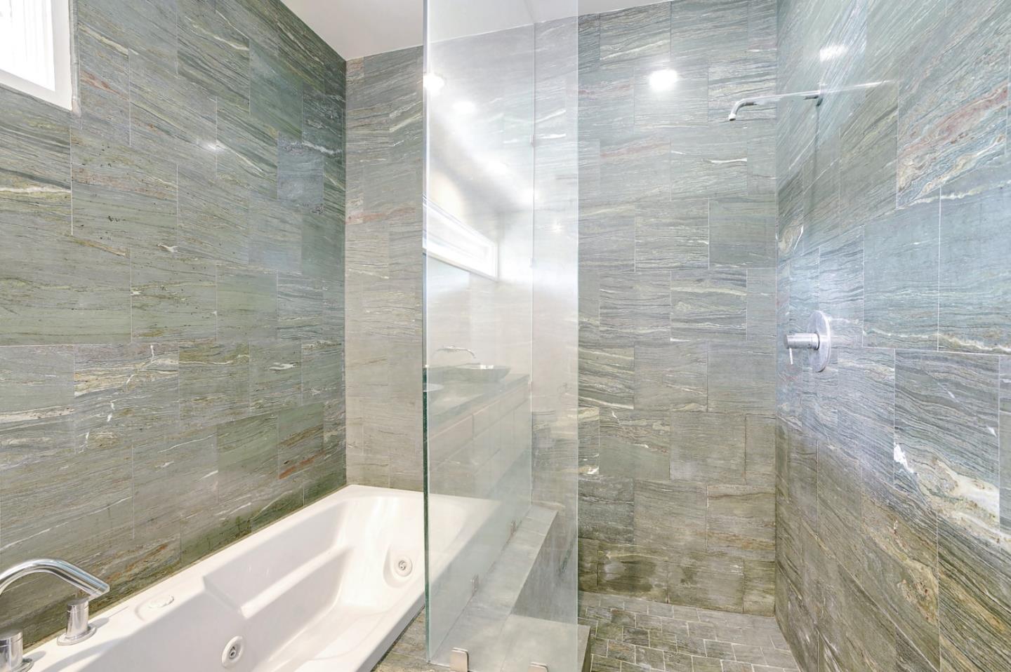 Se Corner Se Corner Carmel, CA 93923 - Photo 30 of 35 a bathroom with a bathtub and a shower