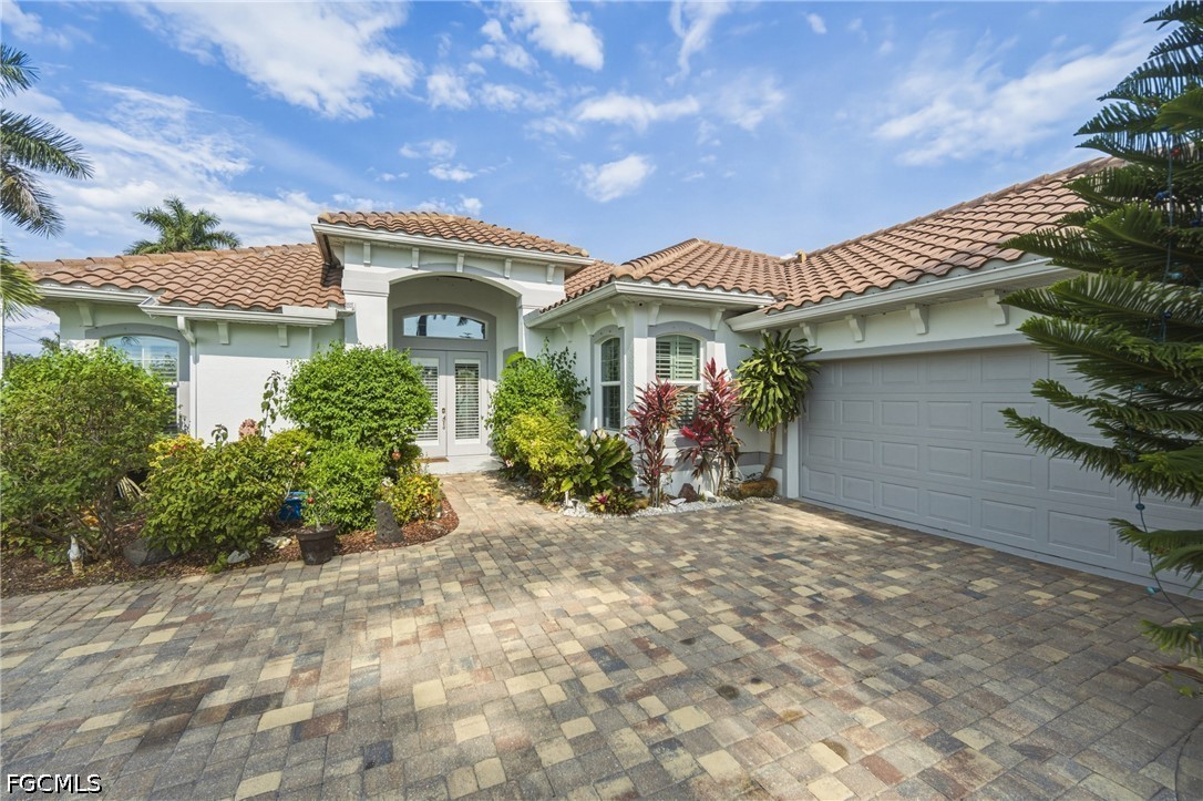 1700 43rd Terrace Southwest Naples, FL 34116 - Photo 4 of 38 a front view of a house with garden