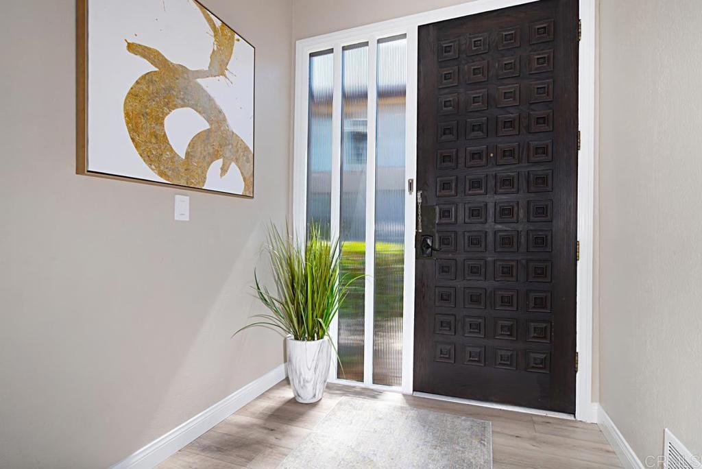1921 Alga Road, Unit B Carlsbad, CA 92009 - Photo 1 of 1 a potted plant in front of a door
