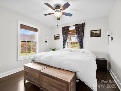 a bedroom with a bed and a large window